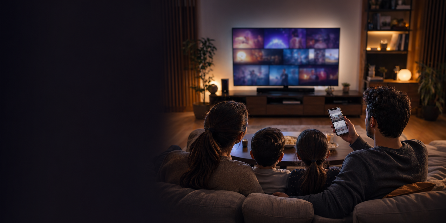 TV izlerken mobil ekran kullanan aile